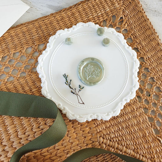 white wax sealing mat with sage green wax seal