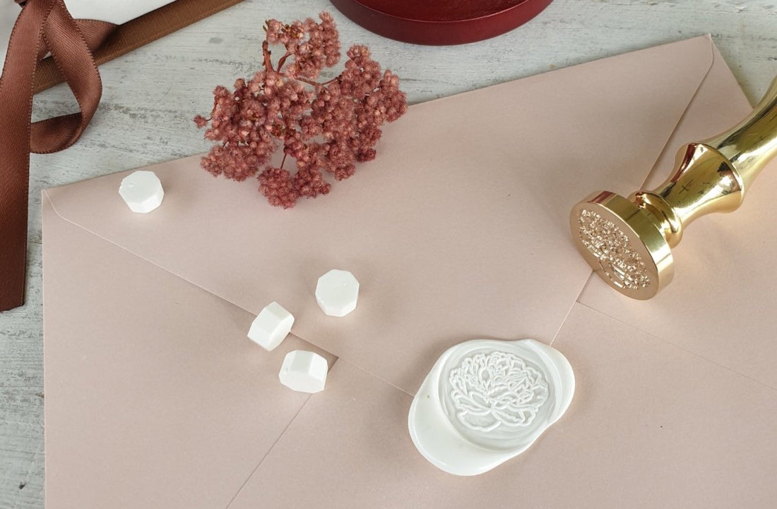 white wax seal on wedding invitation