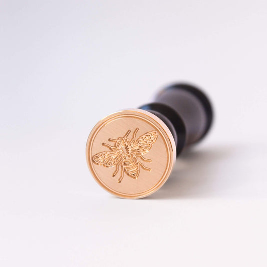 Bee design engraved on brass wax seal head with black wooden handle