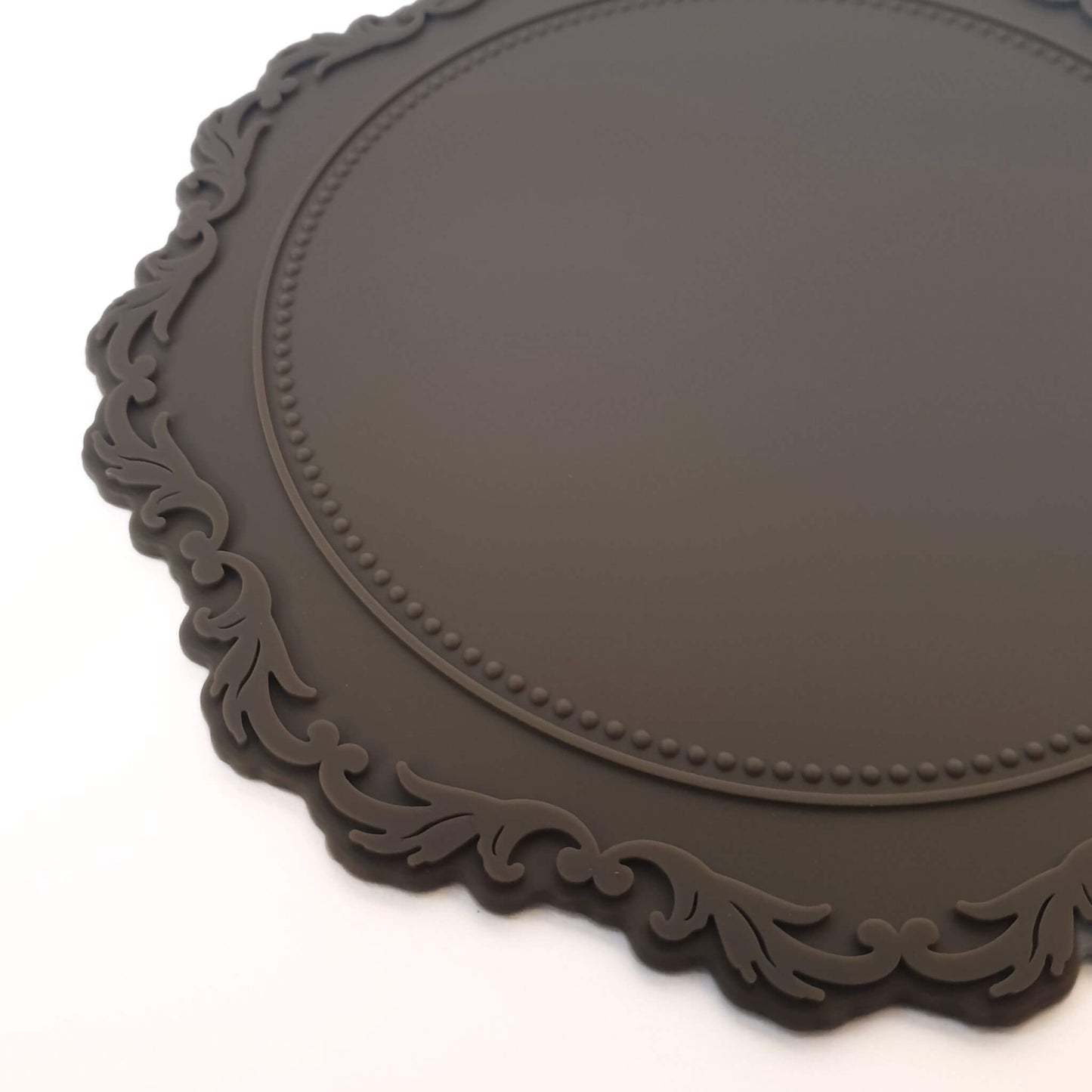 close up of rococo inspired border detail on grey heatproof wax sealing mat