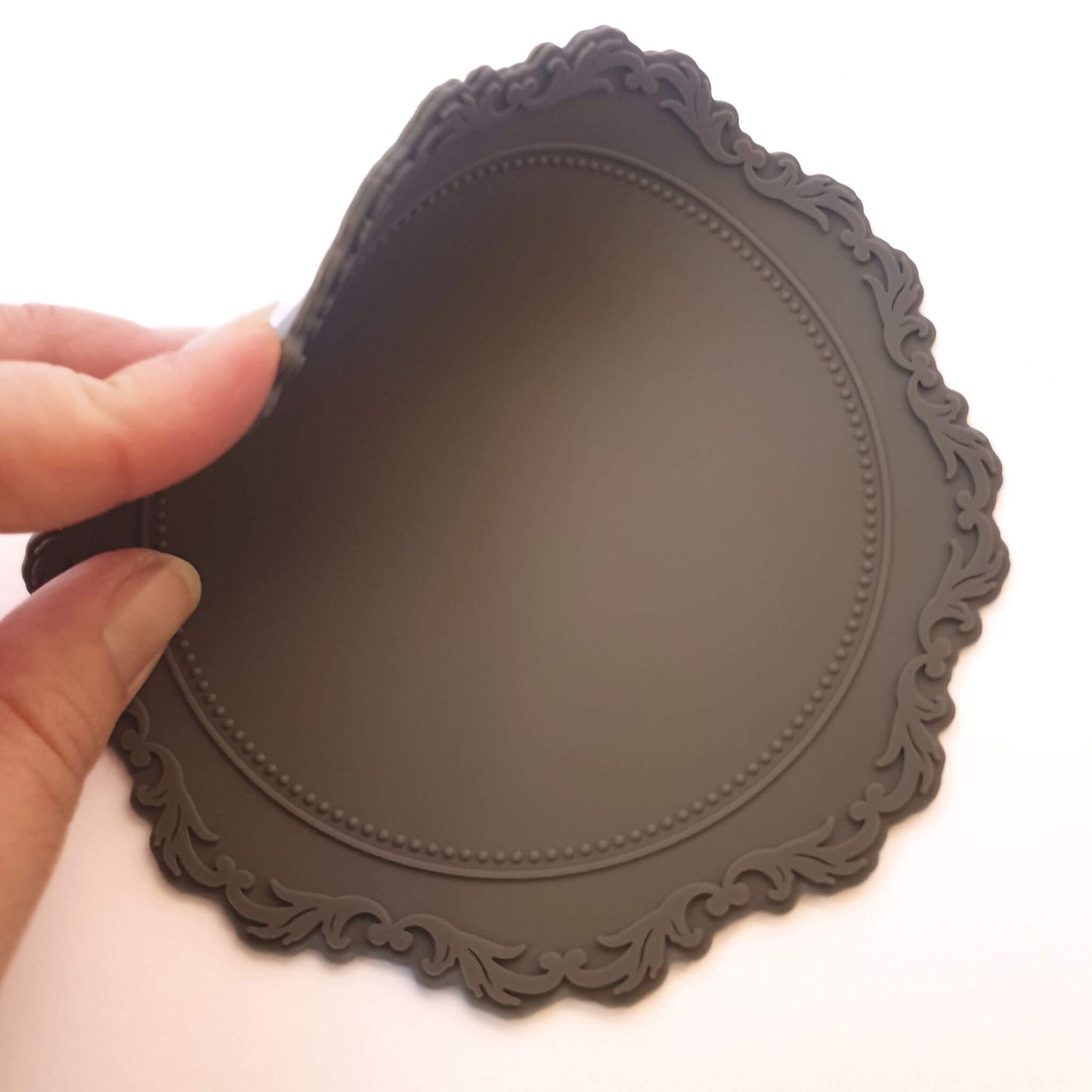 grey wax sealing non stick mat being flexed by fingers