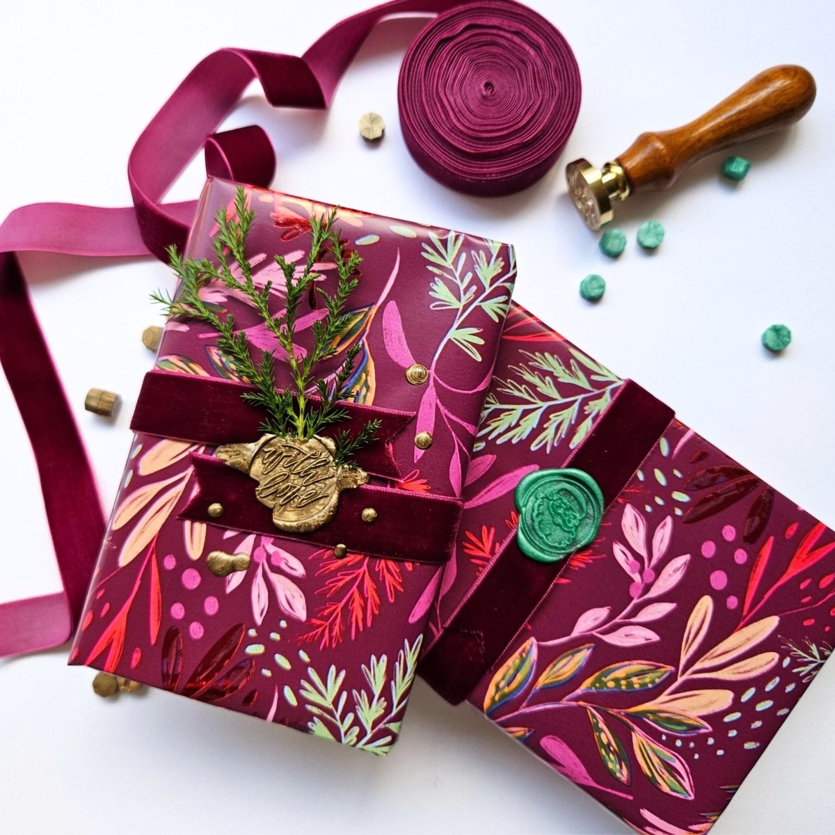 Christmas presents wrapped with purple velvet ribbon and green and gold wax seals