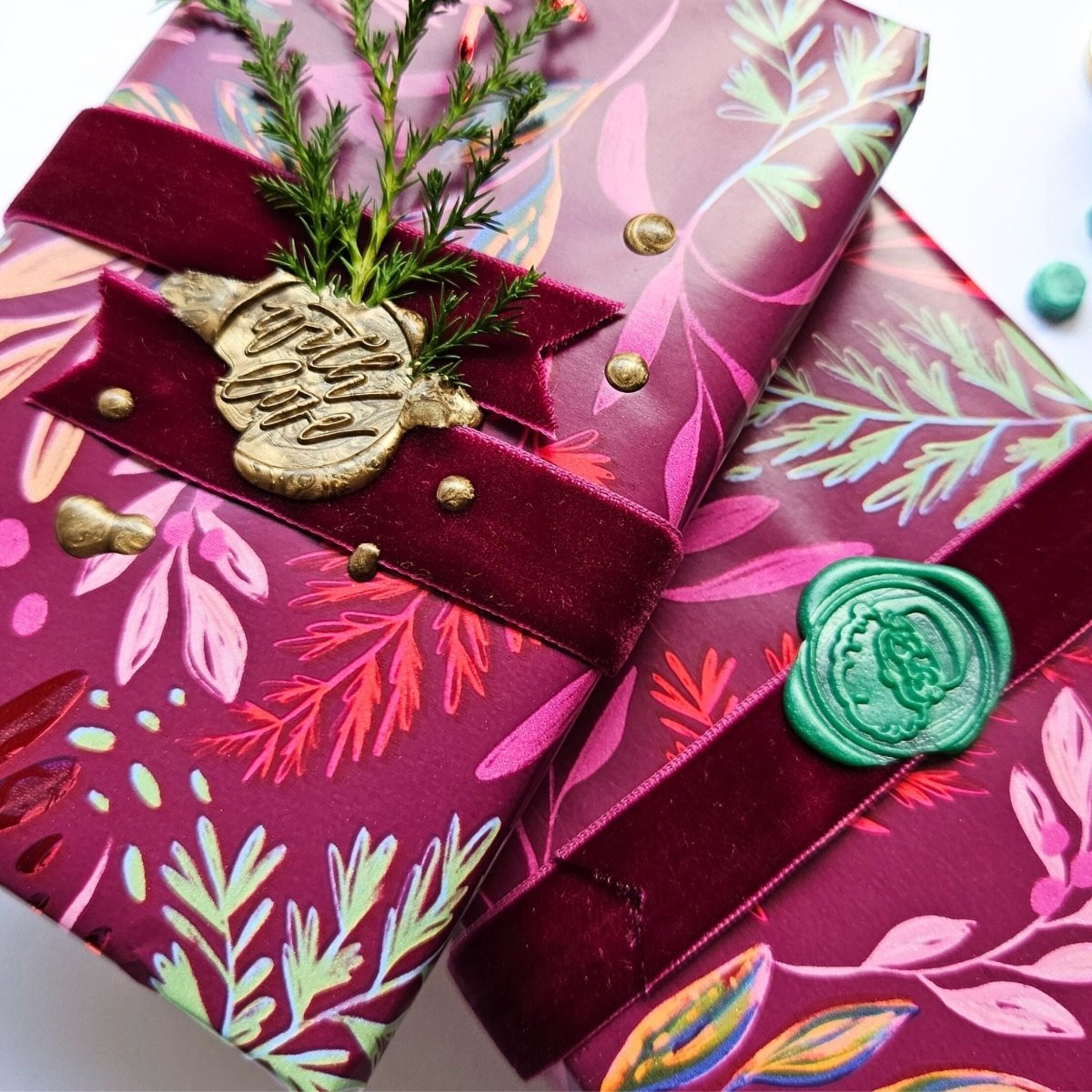 close up of Christmas wax seals on gifts with Santa and script designs