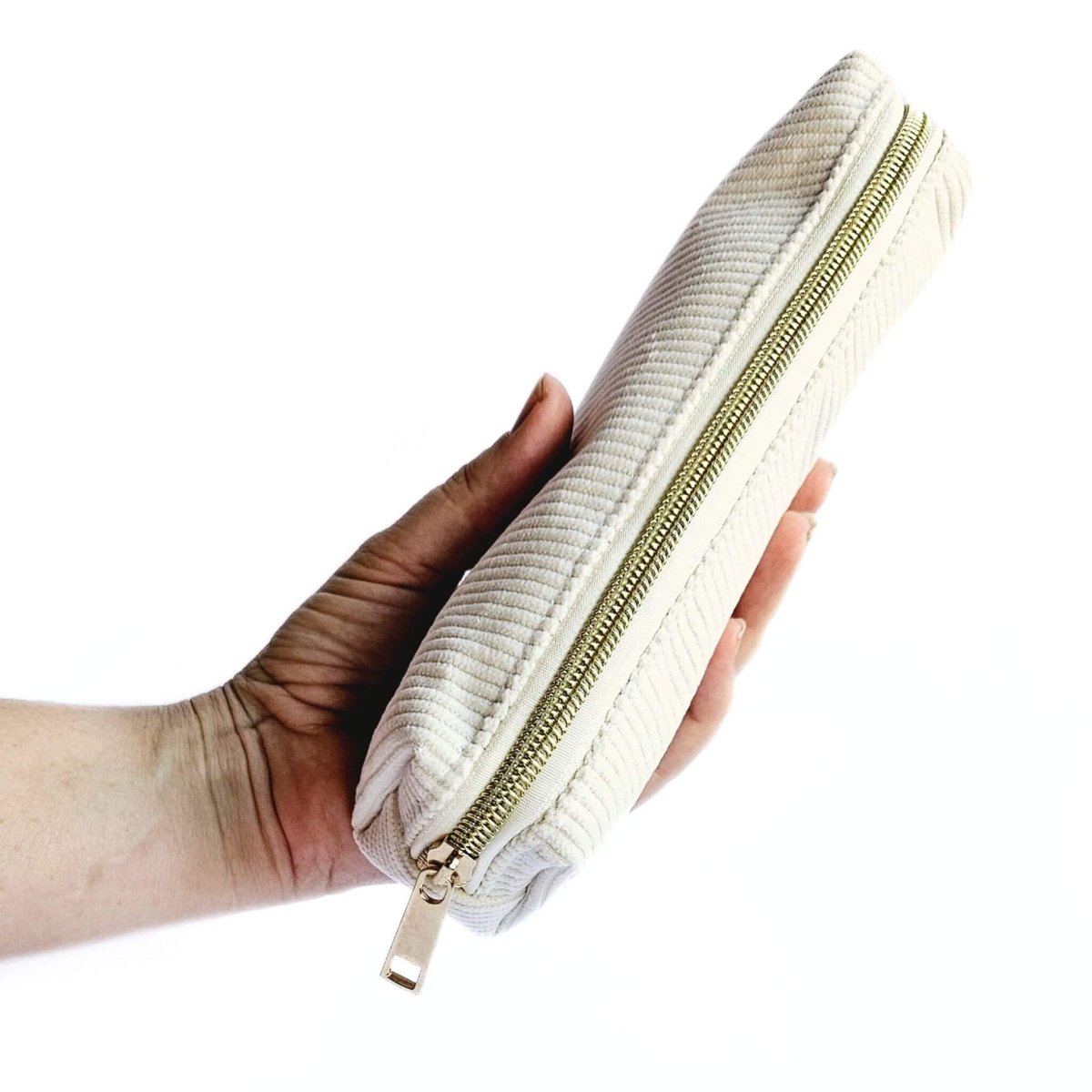 off white cod pen case being held in hand