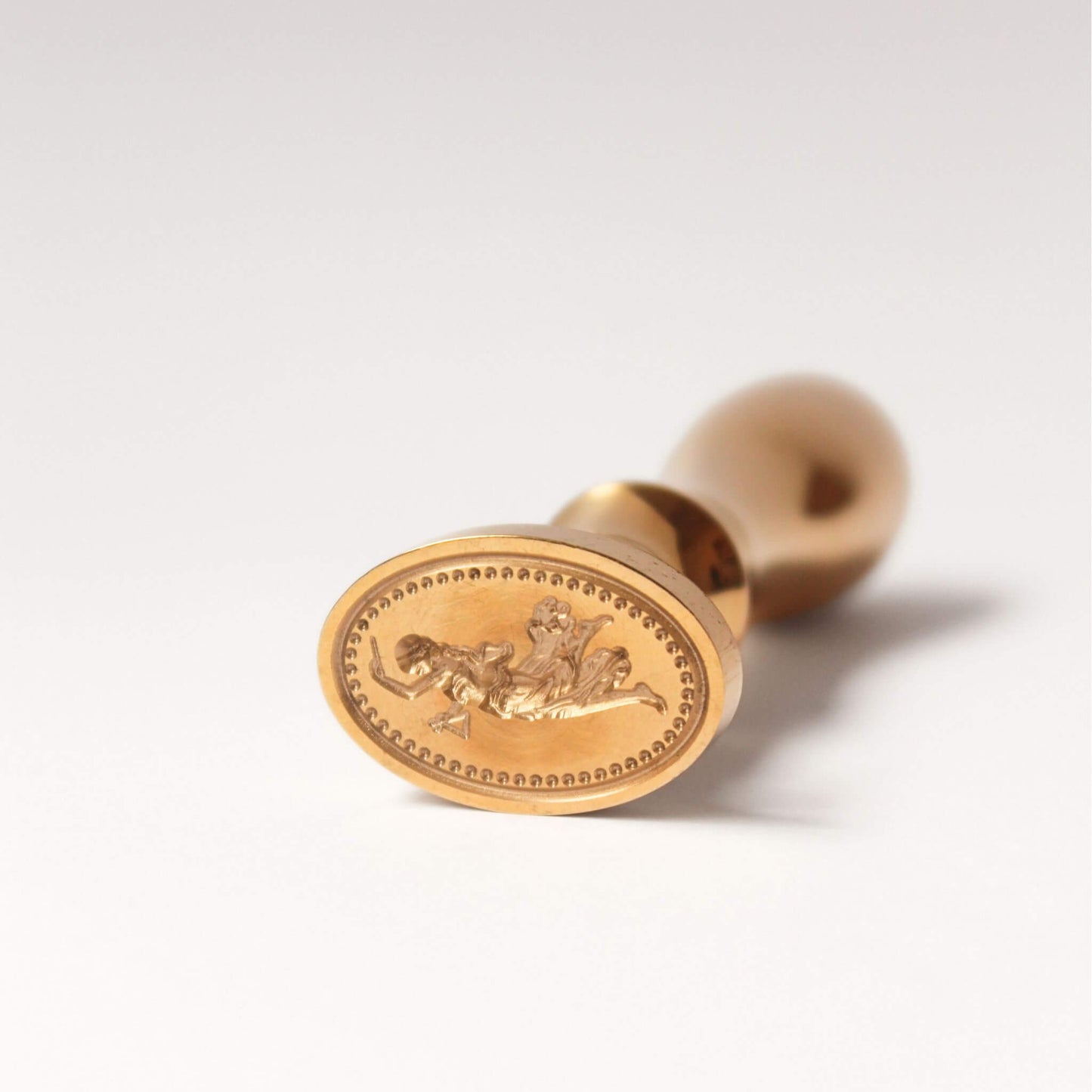 close up of engraving of dancing Goddess on brass wax seal