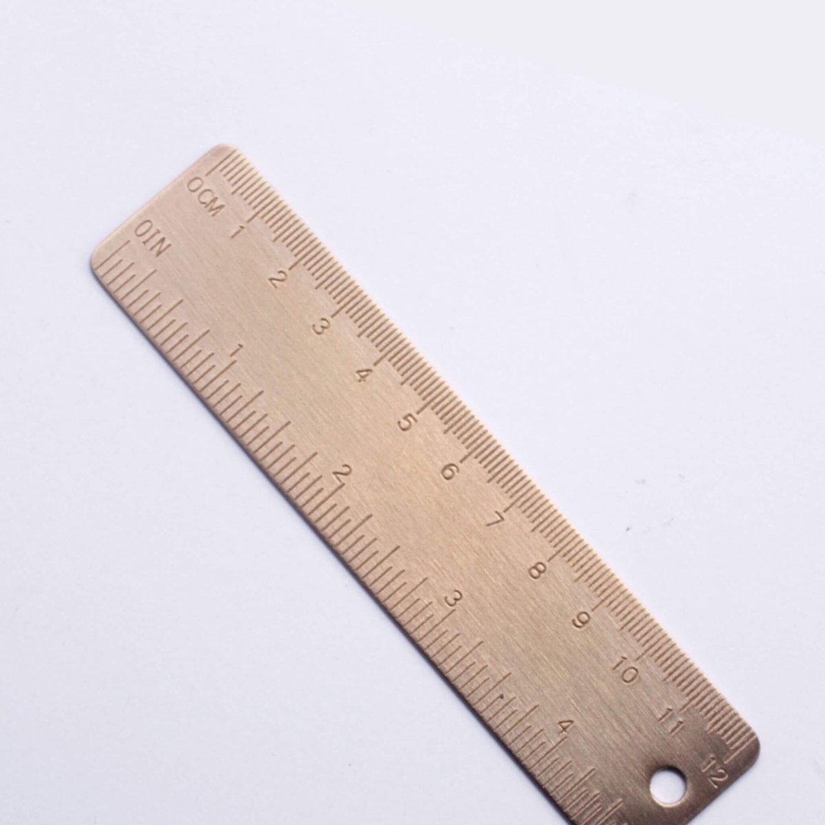 small brass ruler with engraved markings