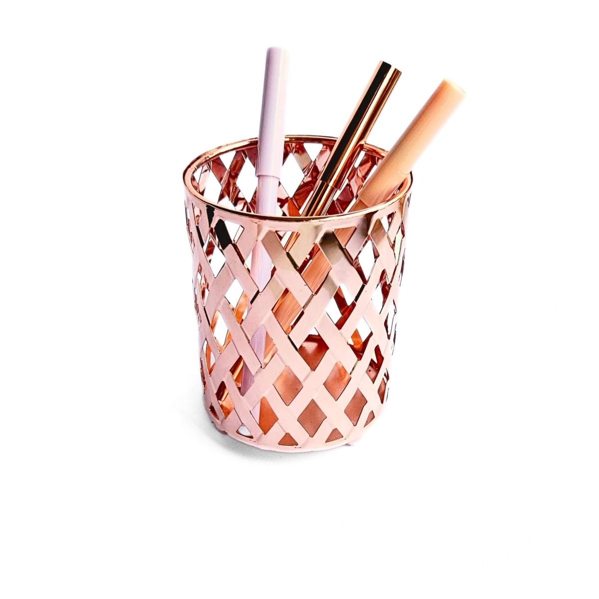 woven metal pen cup in rose gold colour with pens inside