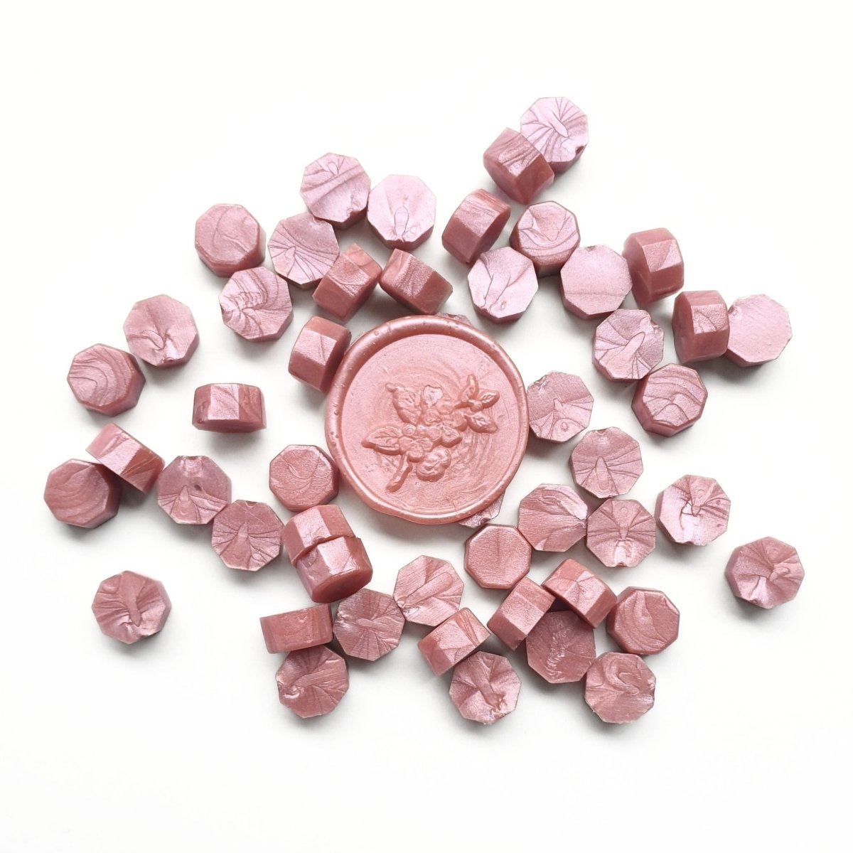 pink wax sealing beads and wax seal with floral design
