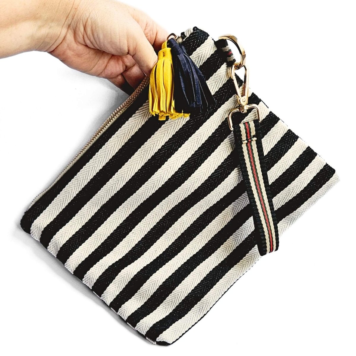 hand holding large pencil case with black and white stripes
