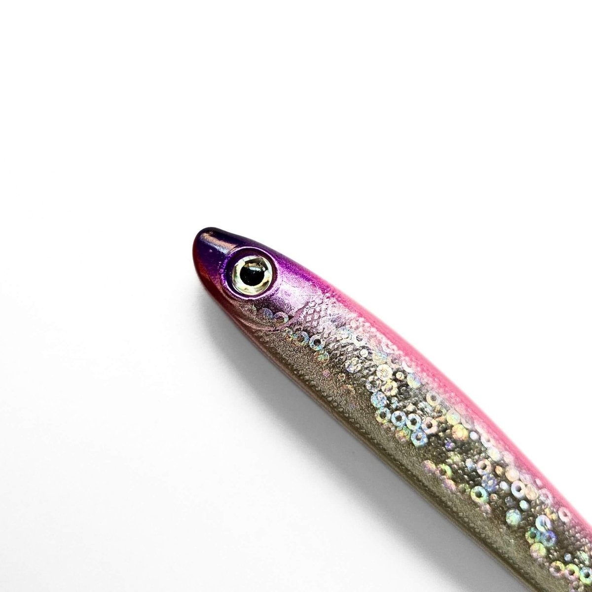 Close-up of a metallic fish pen with a pink and silver gradient color on a white background