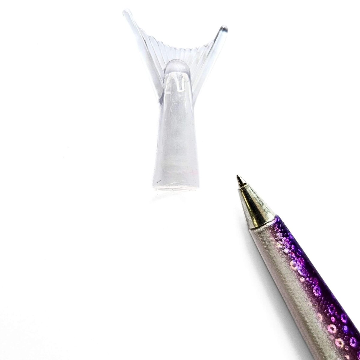 Pen with a glittery purple and silver design and fish tail cap on a white background