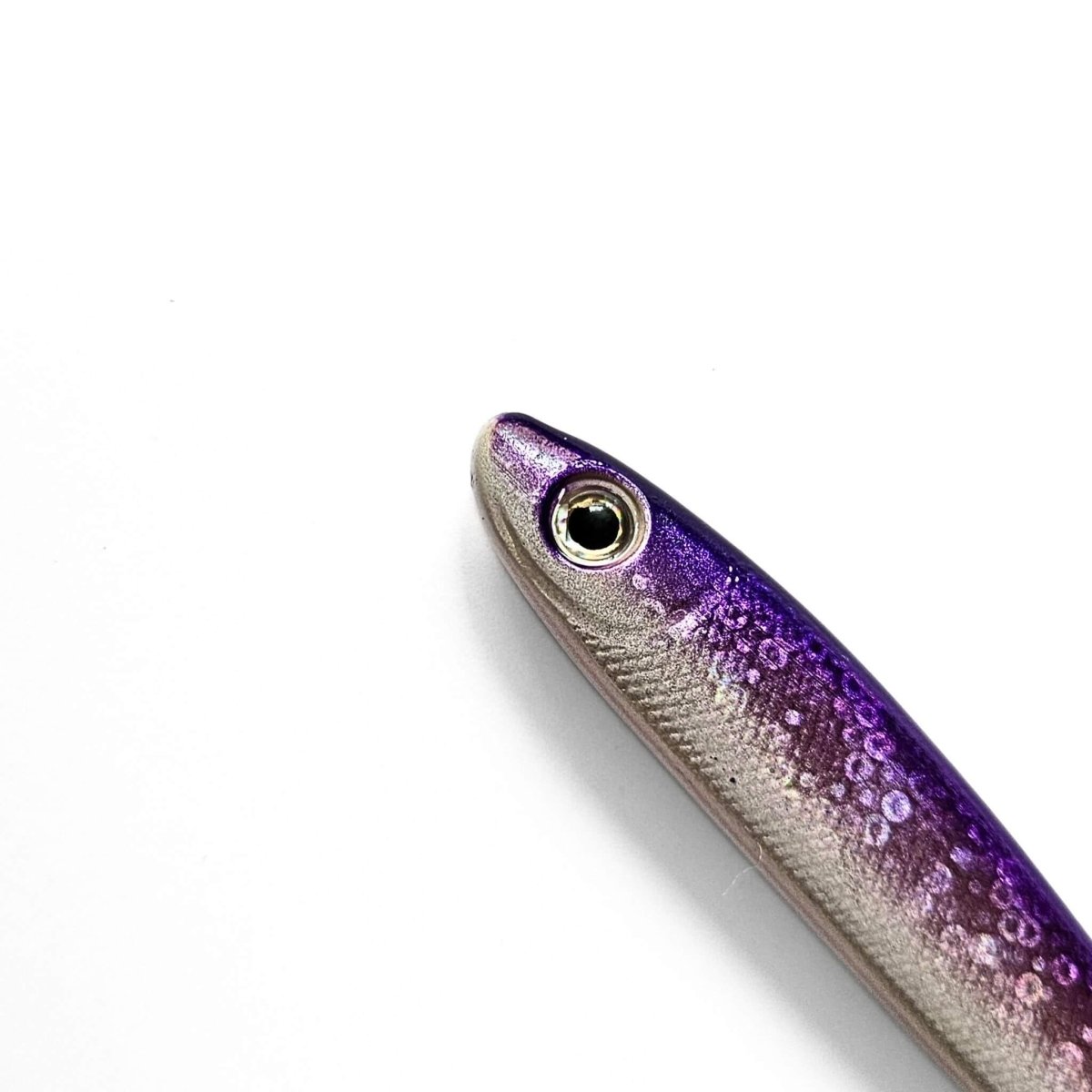 Close-up of a purple and silver sardine shape pen on a white background