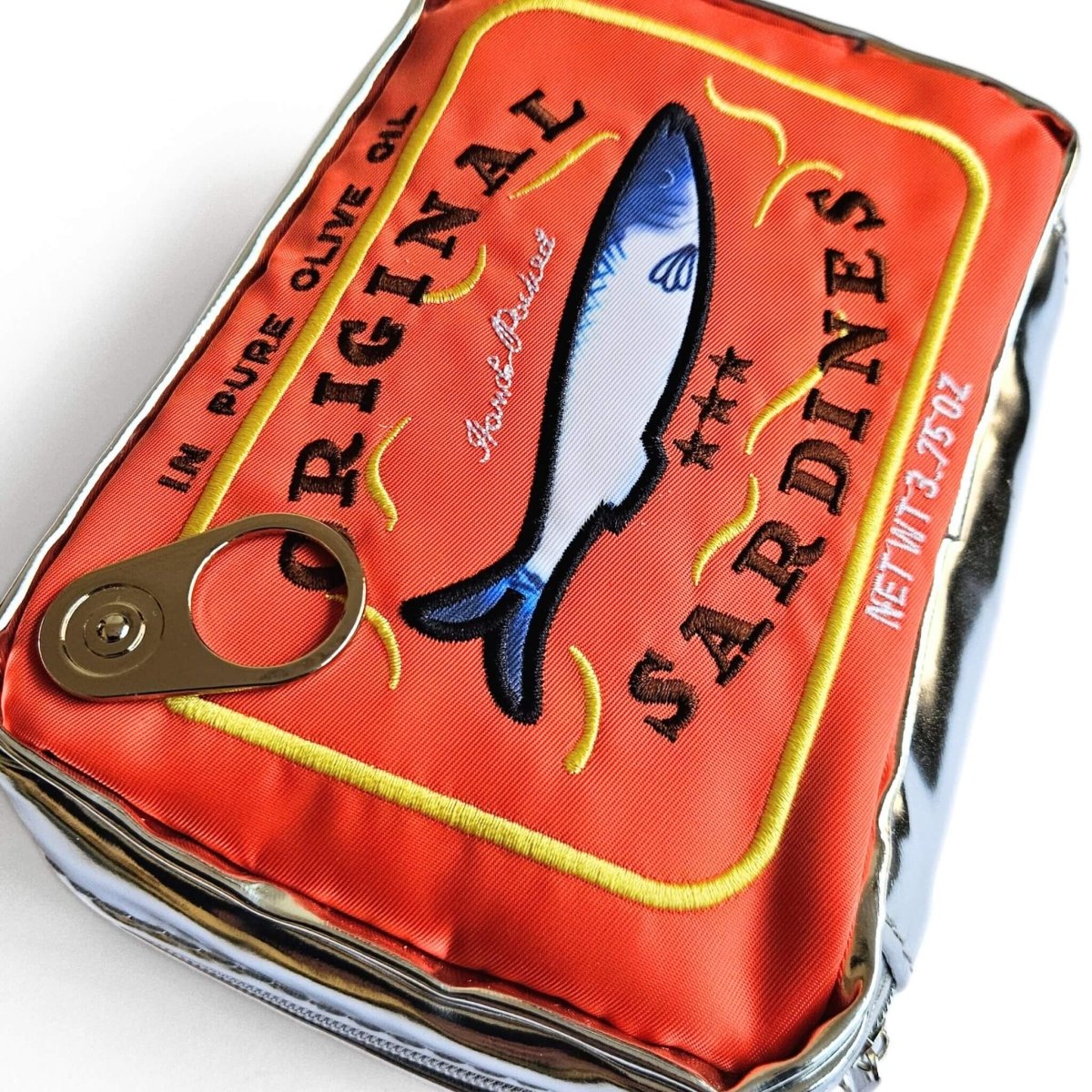 Orange sardine can-shaped pencil pouch on a white background