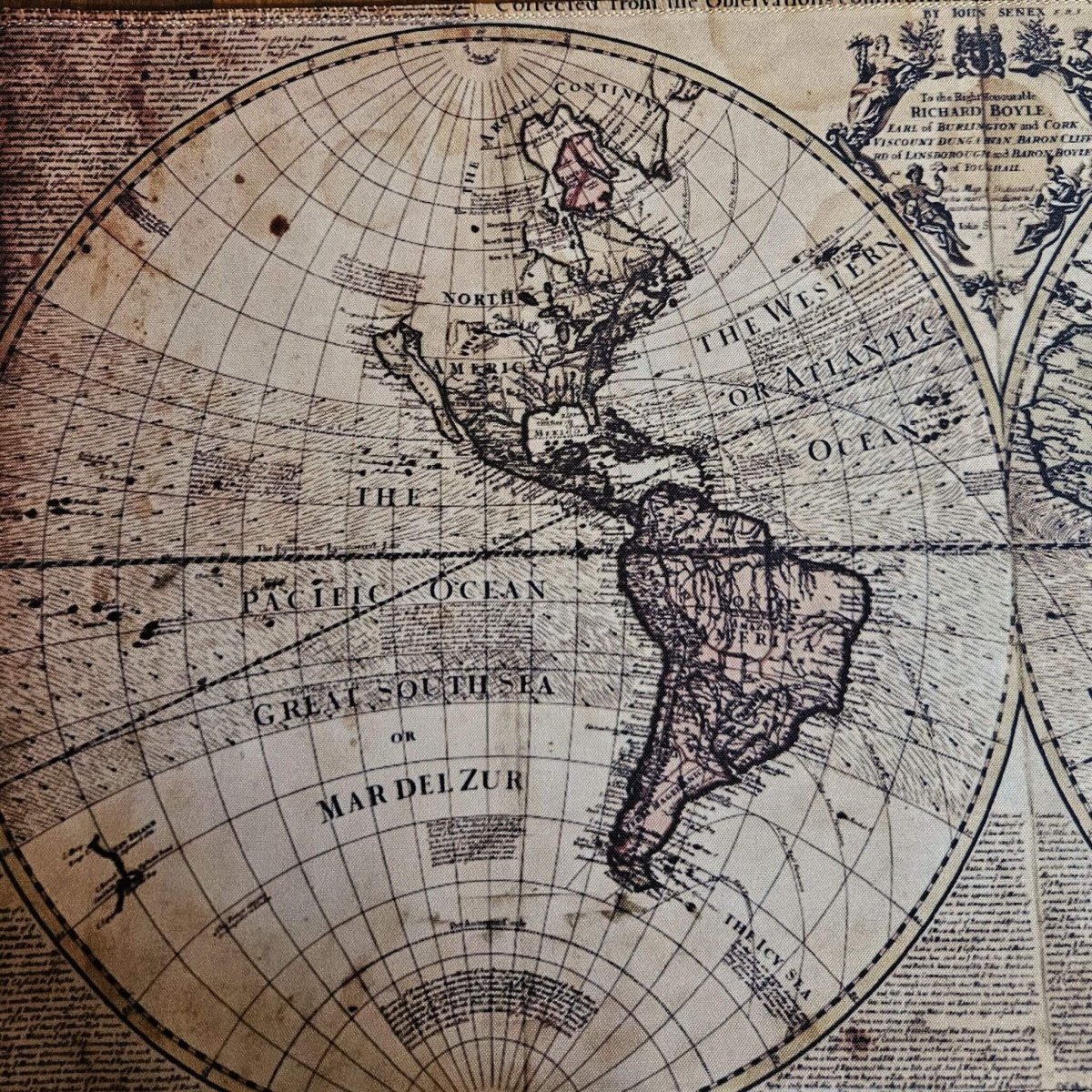 close up detail of antique map design on desk mat