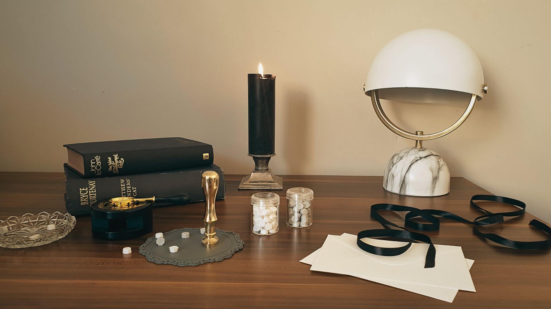 vintage style stationery tools on brown wood desk with lamp