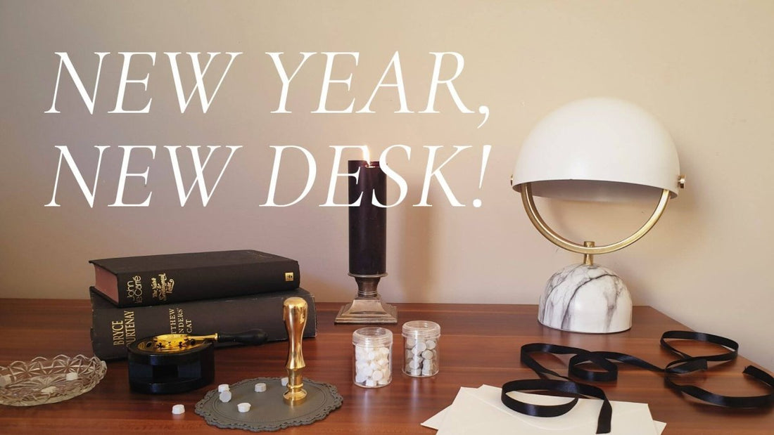 home office desk with lamp, candle, books and stationery
