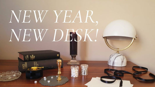 home office desk with lamp, candle, books and stationery