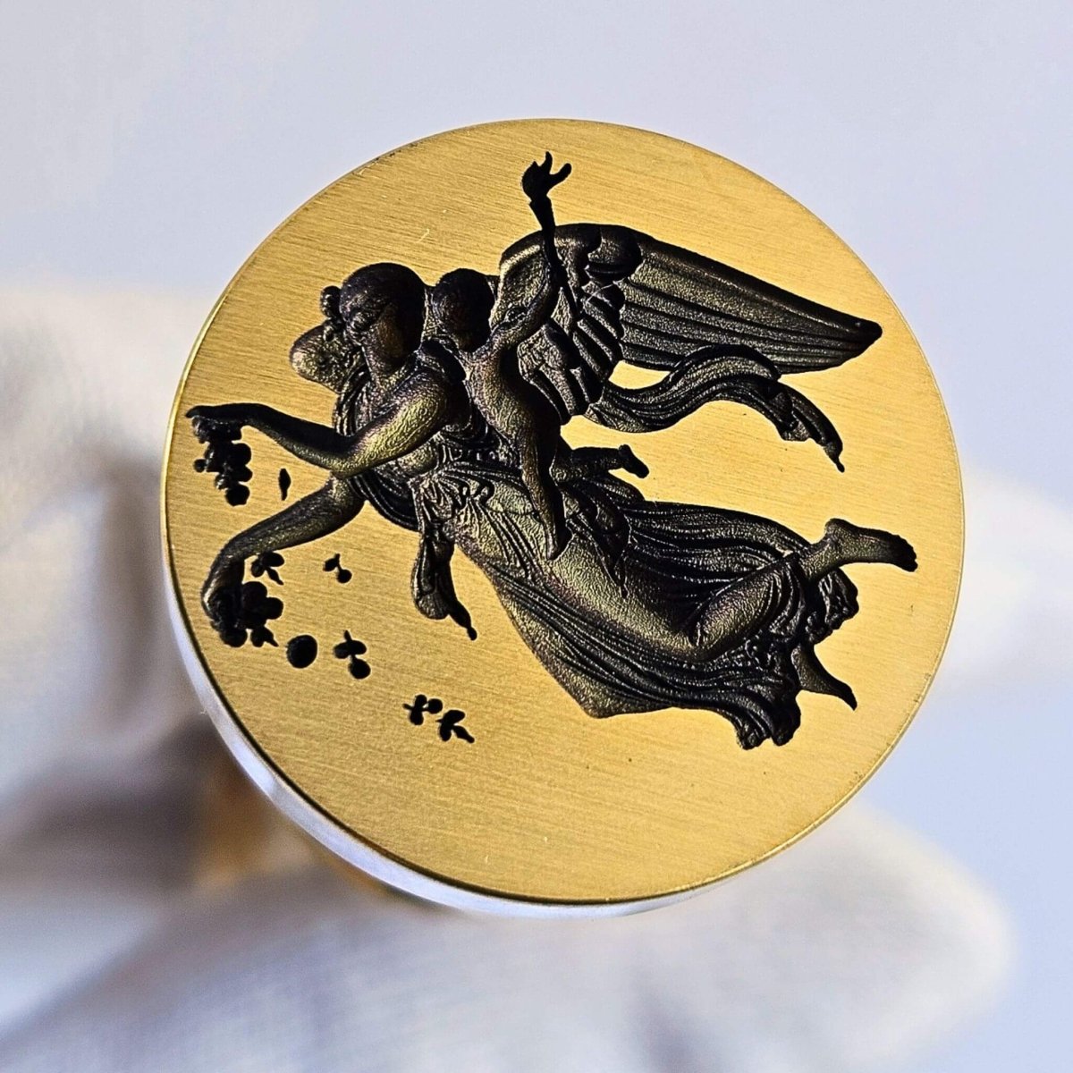 Winged Goddess Eos with cherub design on brass wax seal head