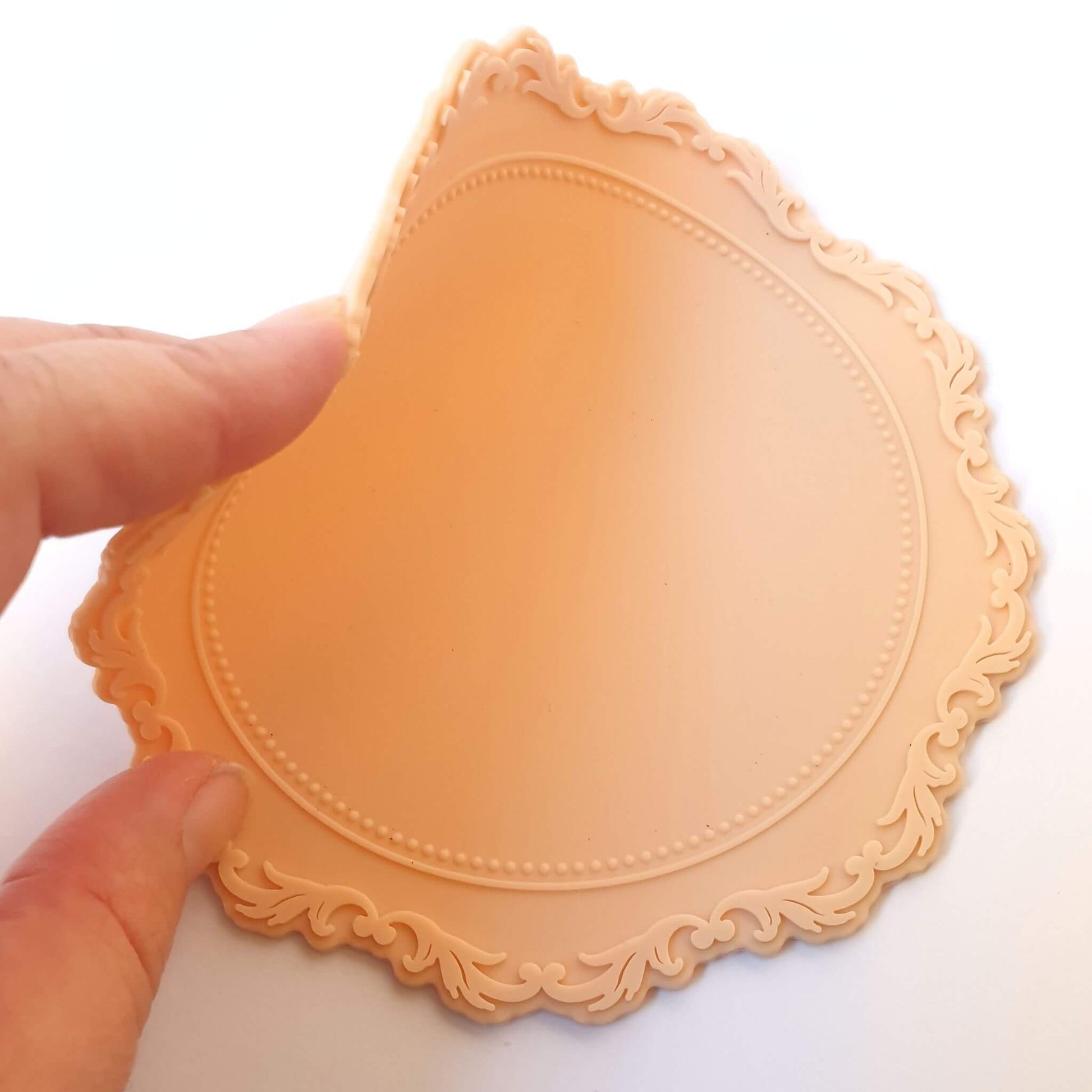 nude colour silicone wax sealing mat being bent by hand