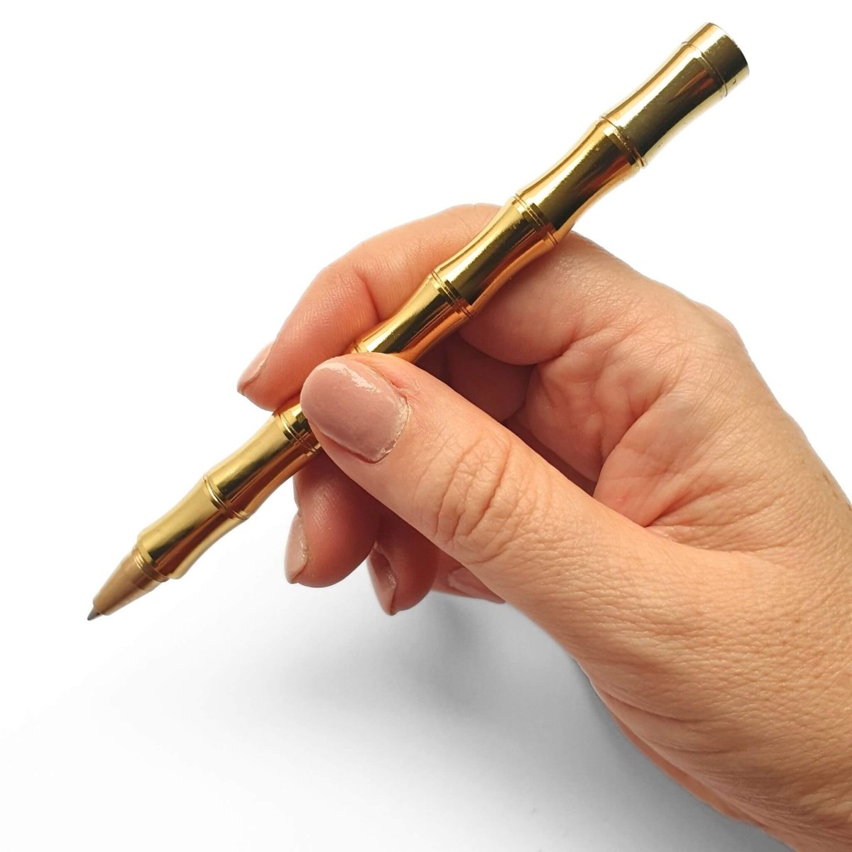 Bamboo Brass Pen being held in hand - Bounde