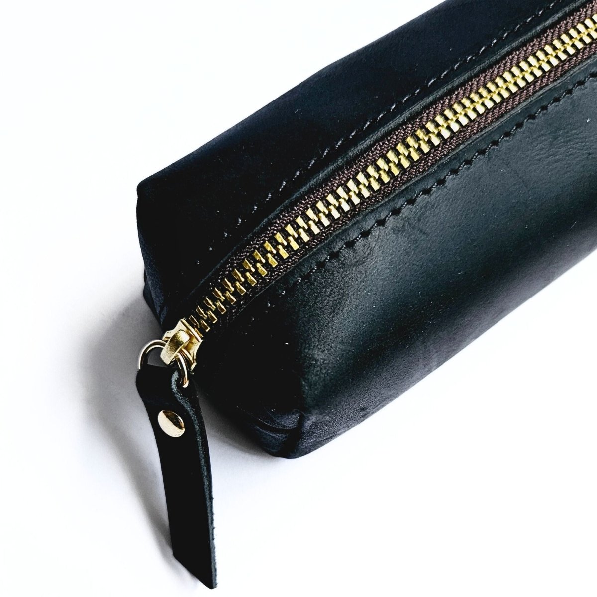 close up detail of black leather pencil case