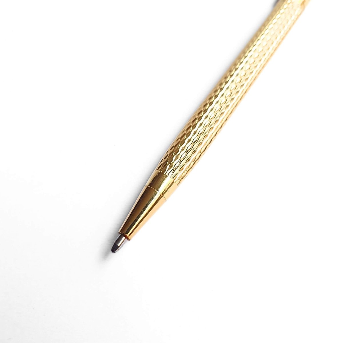 close up of gold pen ballpoint tip