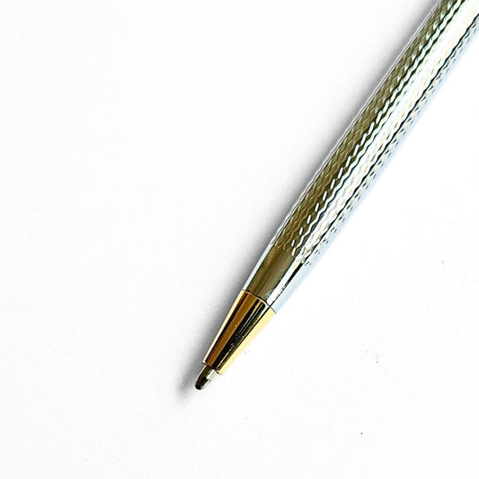 Metallic pen with gold accent on a white background