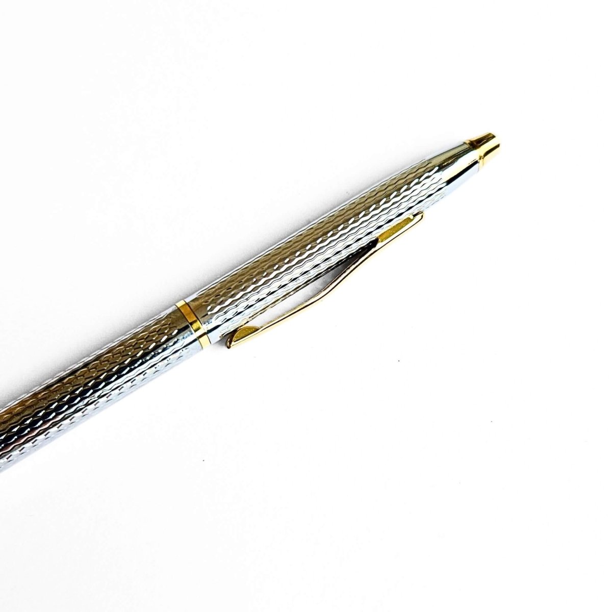 Metallic pen with gold accents on a white background