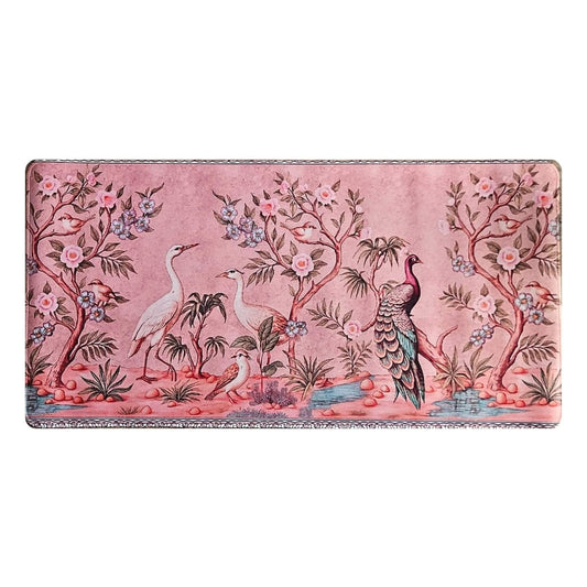 Decorative desk mat with bird and floral design on a pink background