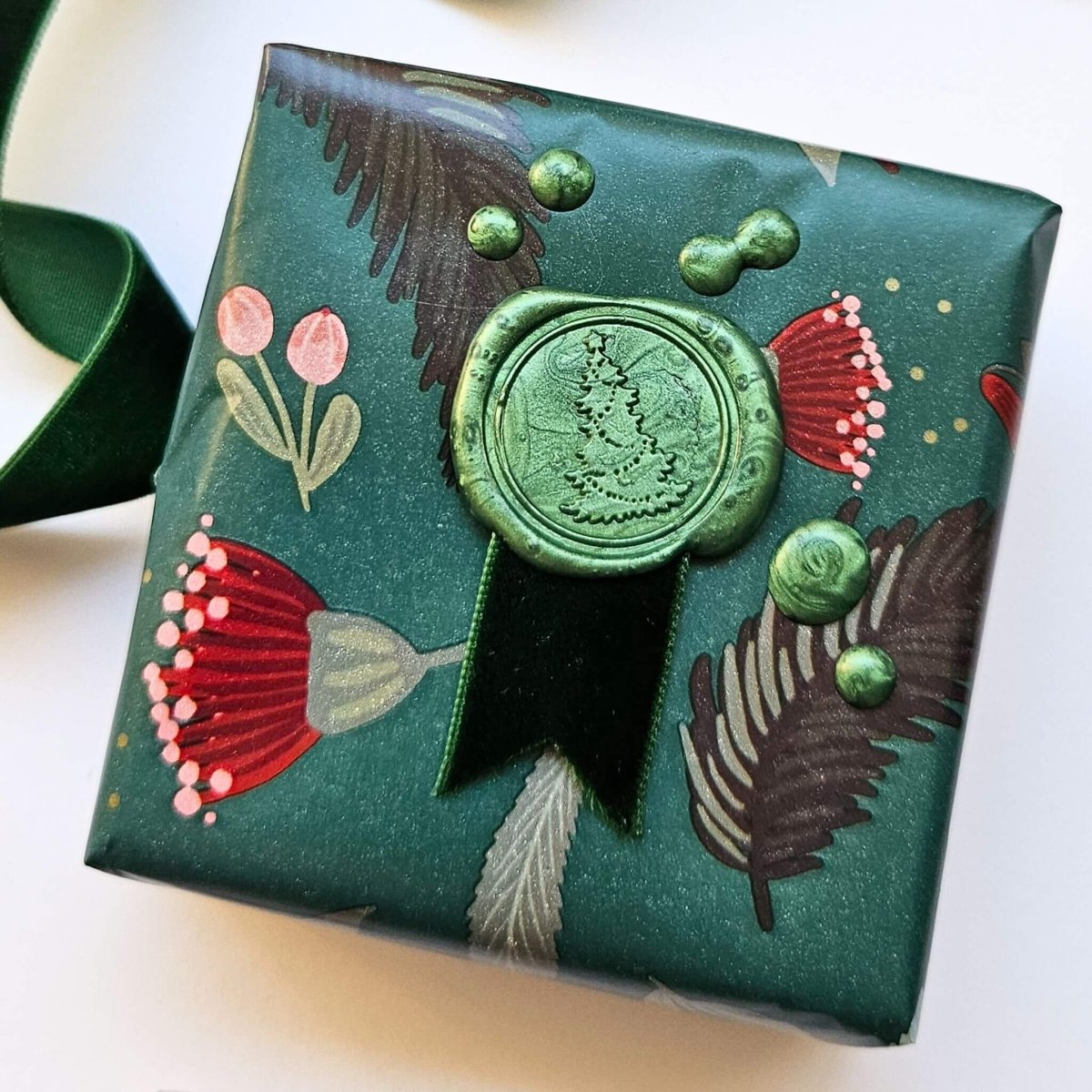 wax seal with Christmas tree design on gift