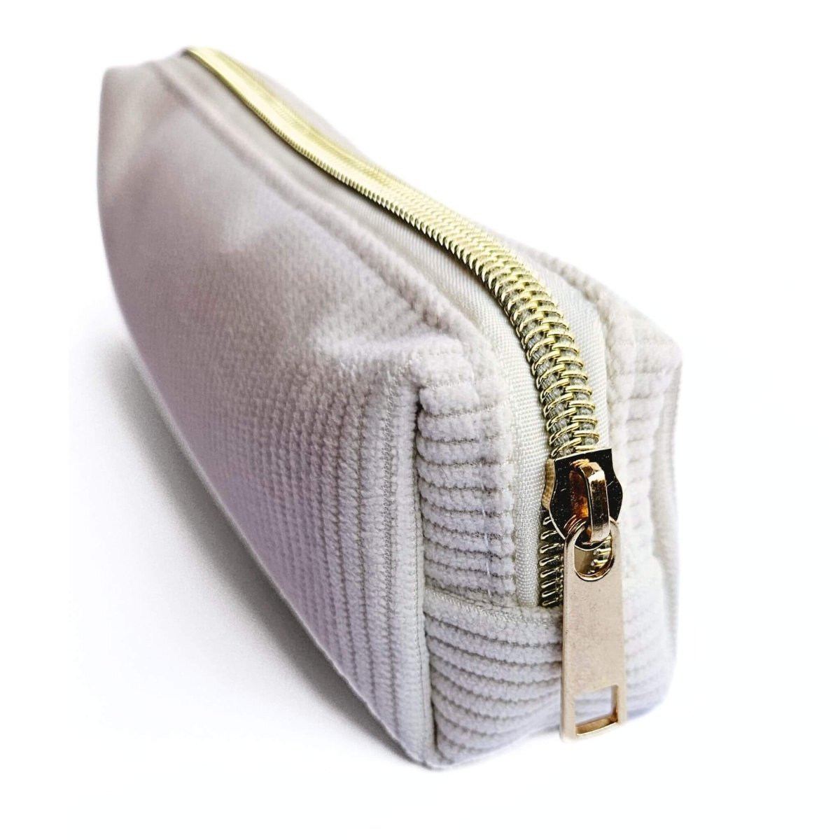 front view of gold zipper on cream corduroy pencil case