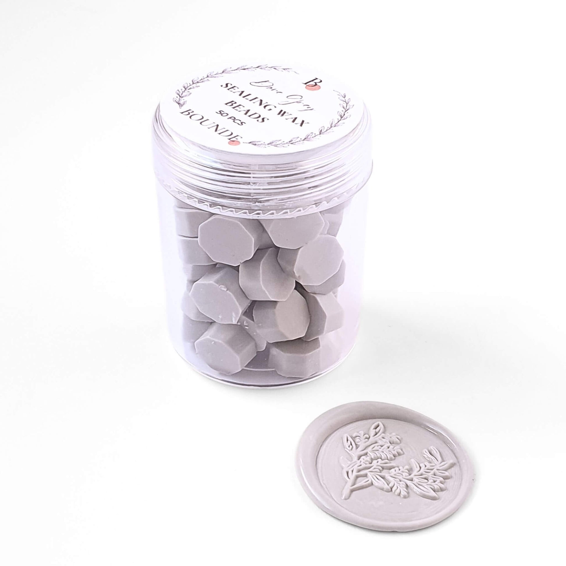 Dove Grey Sealing Wax Beads in jar with light grey wax seal next to it