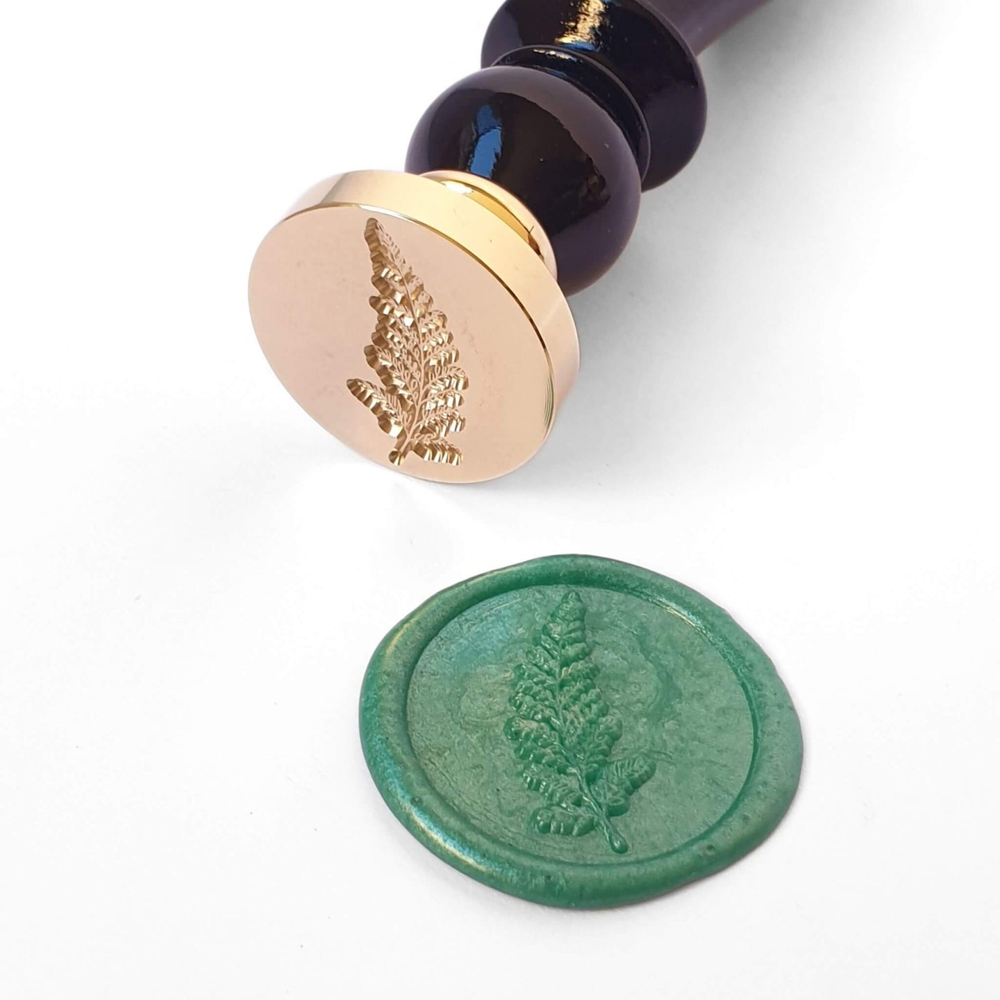Brass wax seal with fern leaf engraving and black wooden handle
