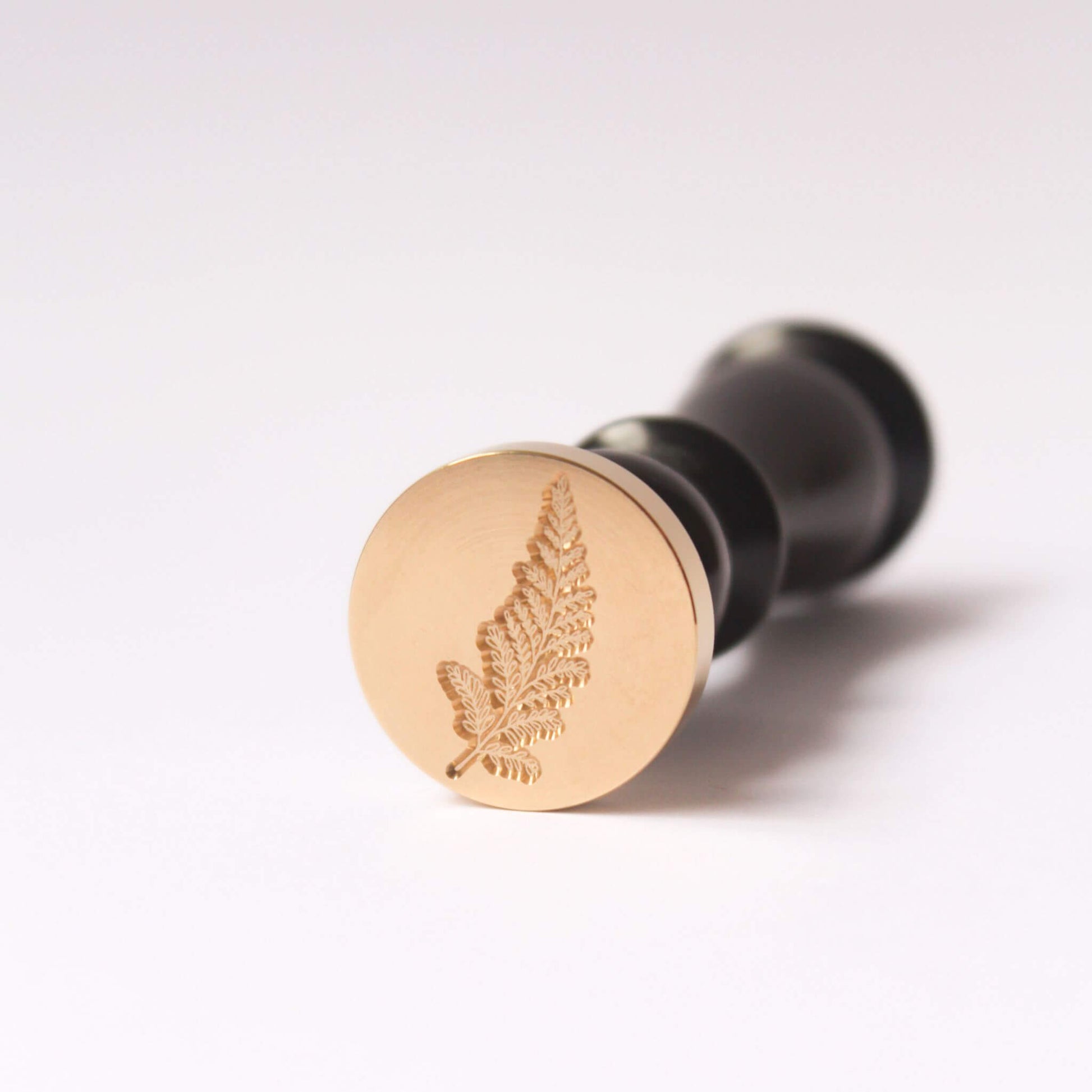 Fern design engraved onto brass wax seal head with vintage style black wood handle