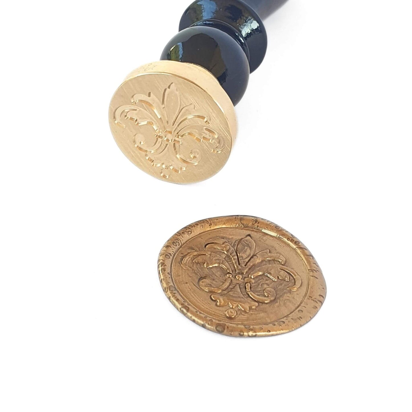 Florentine fleur de lis symbol engraved on brass wax seal with black wood handle next to antique gold wax seal