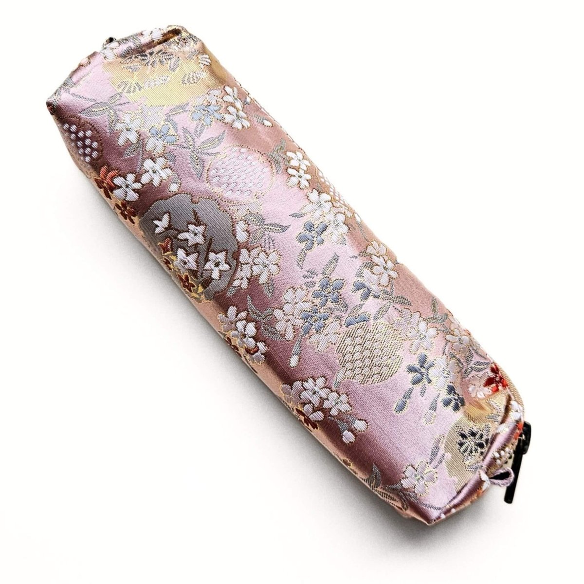 Pink and gold floral pencil case on white background