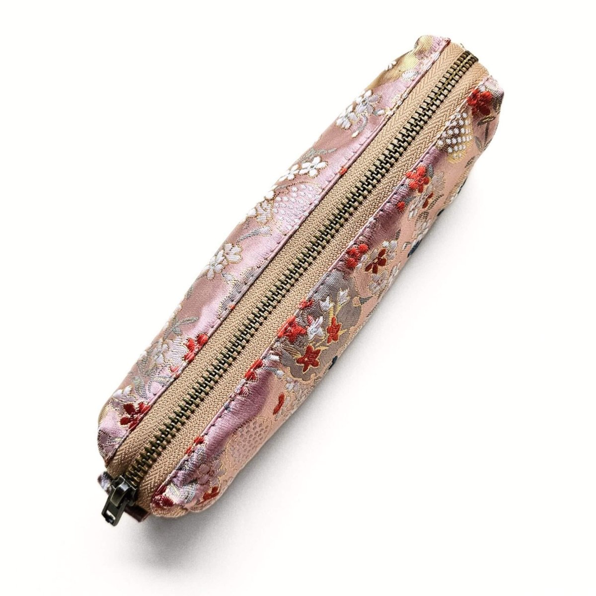 Pink floral-patterned pencil case with a zipper on a white background