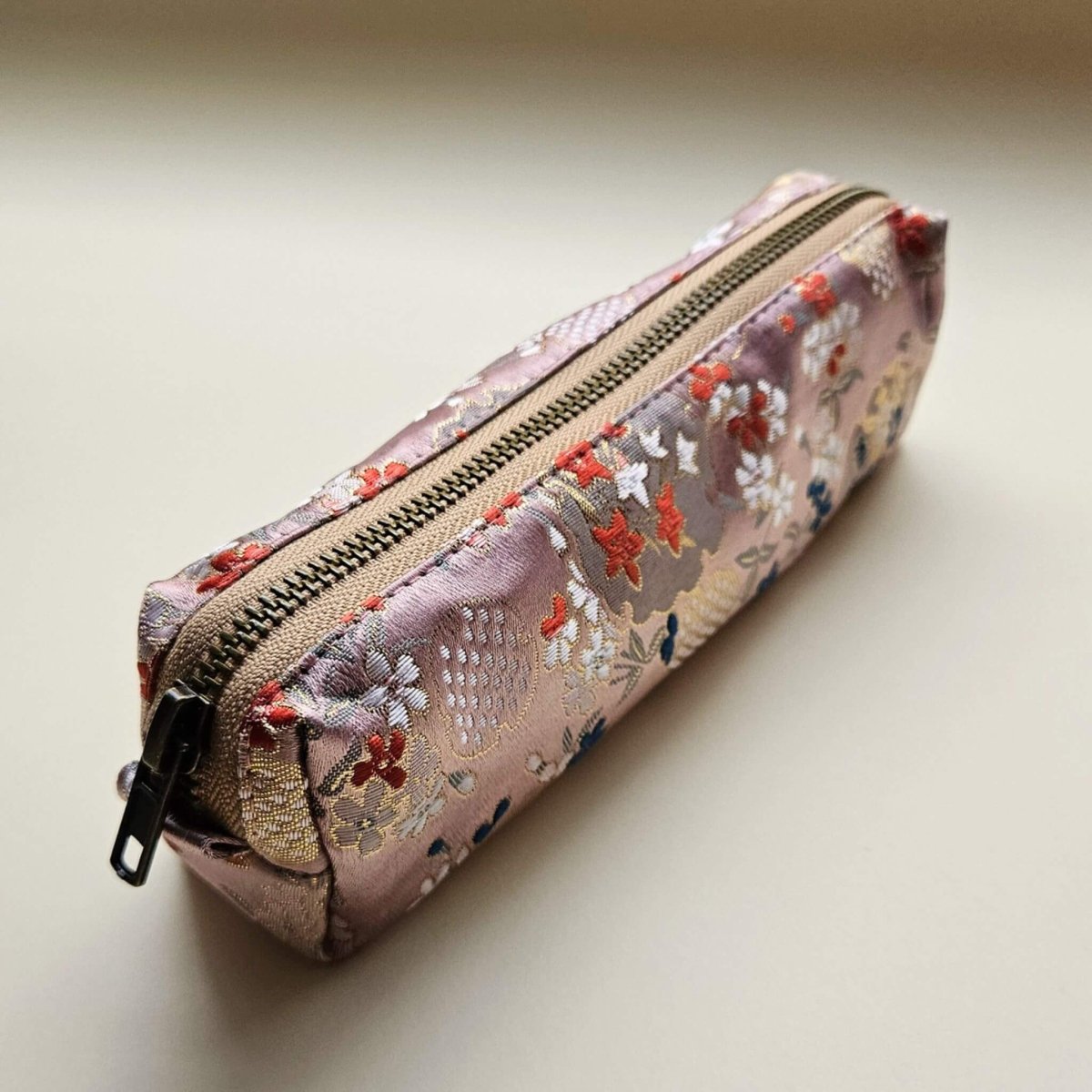 Floral embroidered pencil case on a light background