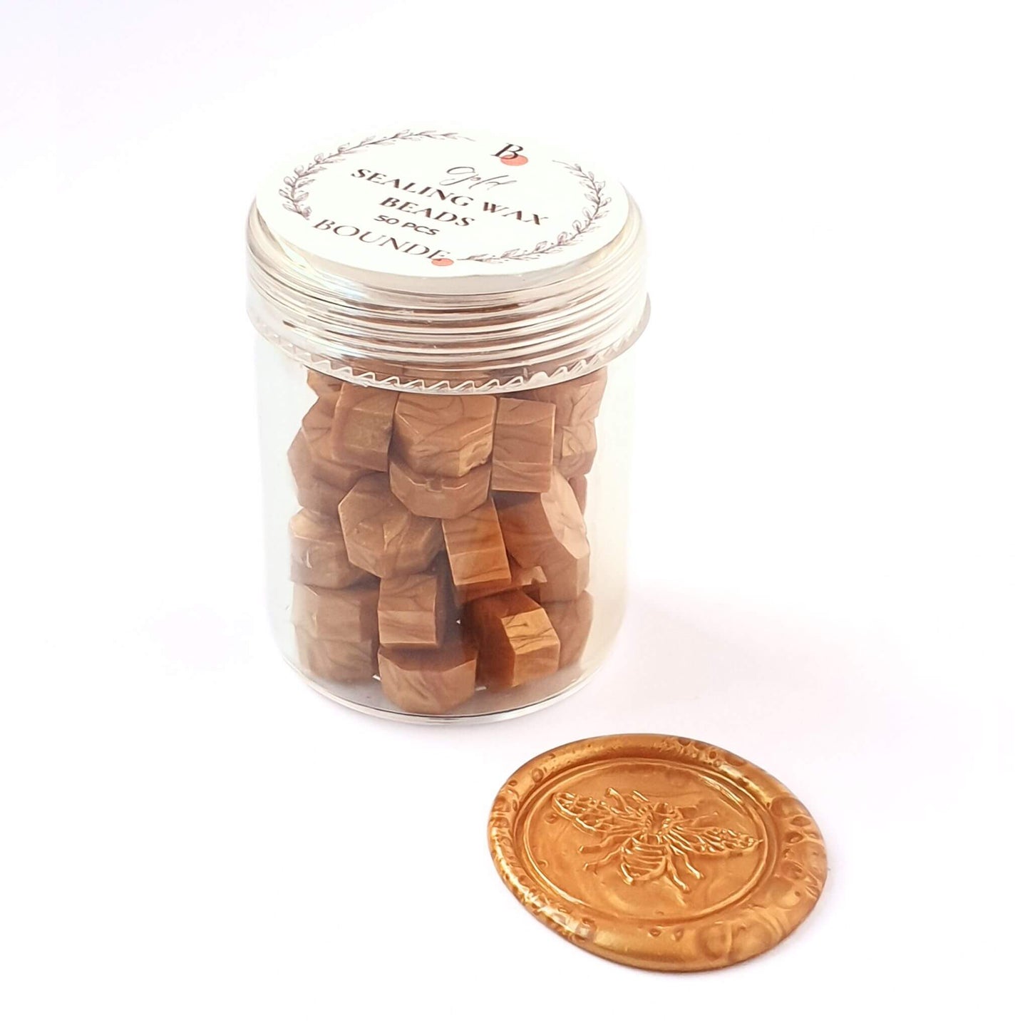 gold sealing wax beads in jar with gold wax seal