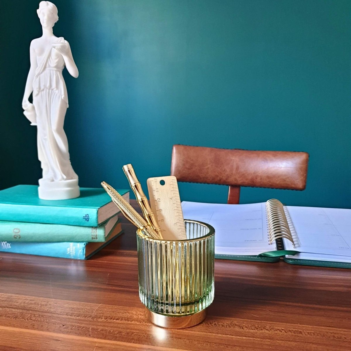 ribbed glass pen holder on desk in office