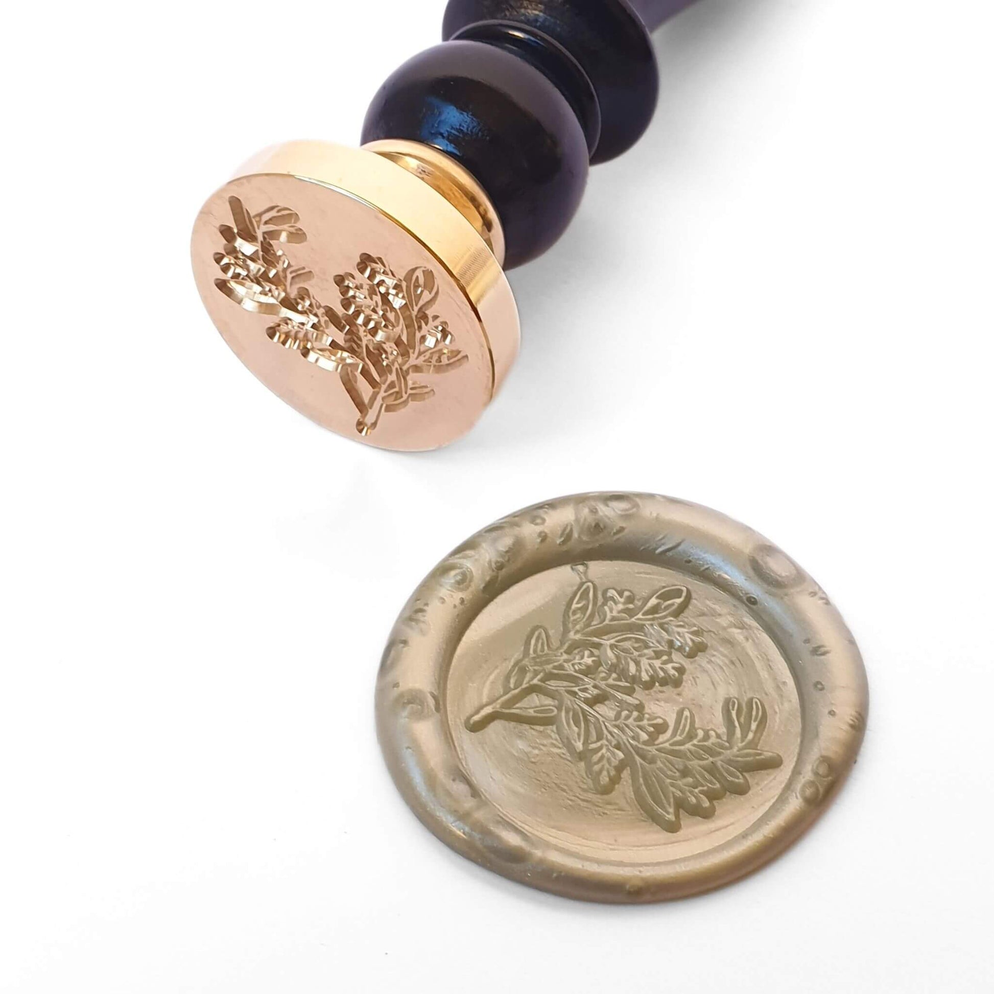 Brass wax seal with black handle and foliage engraving