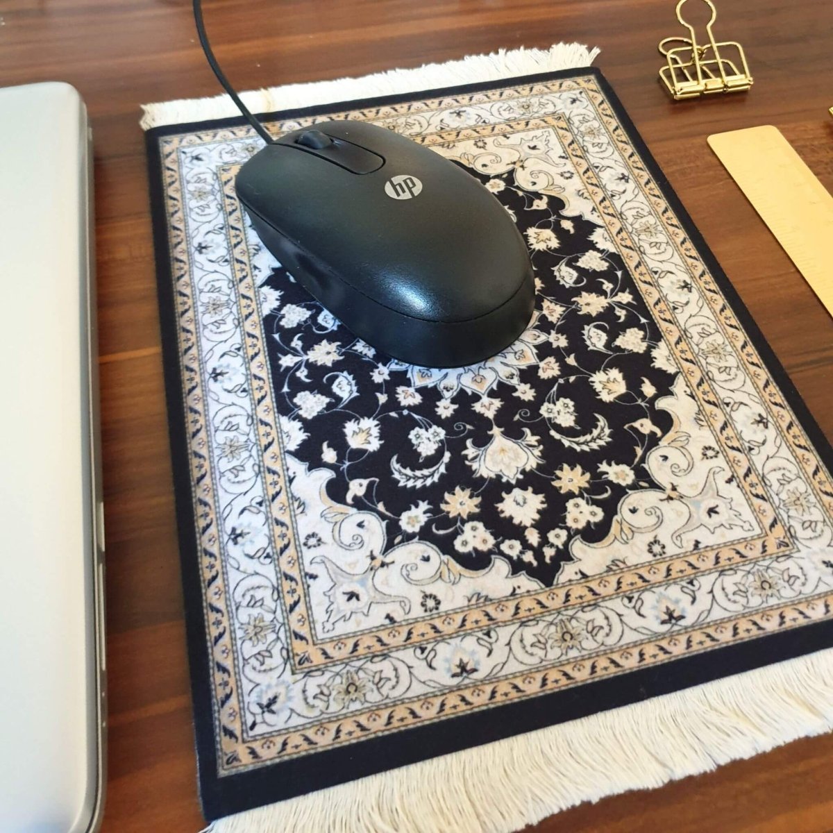 computer mouse on Persian rug mouse pad on office desk