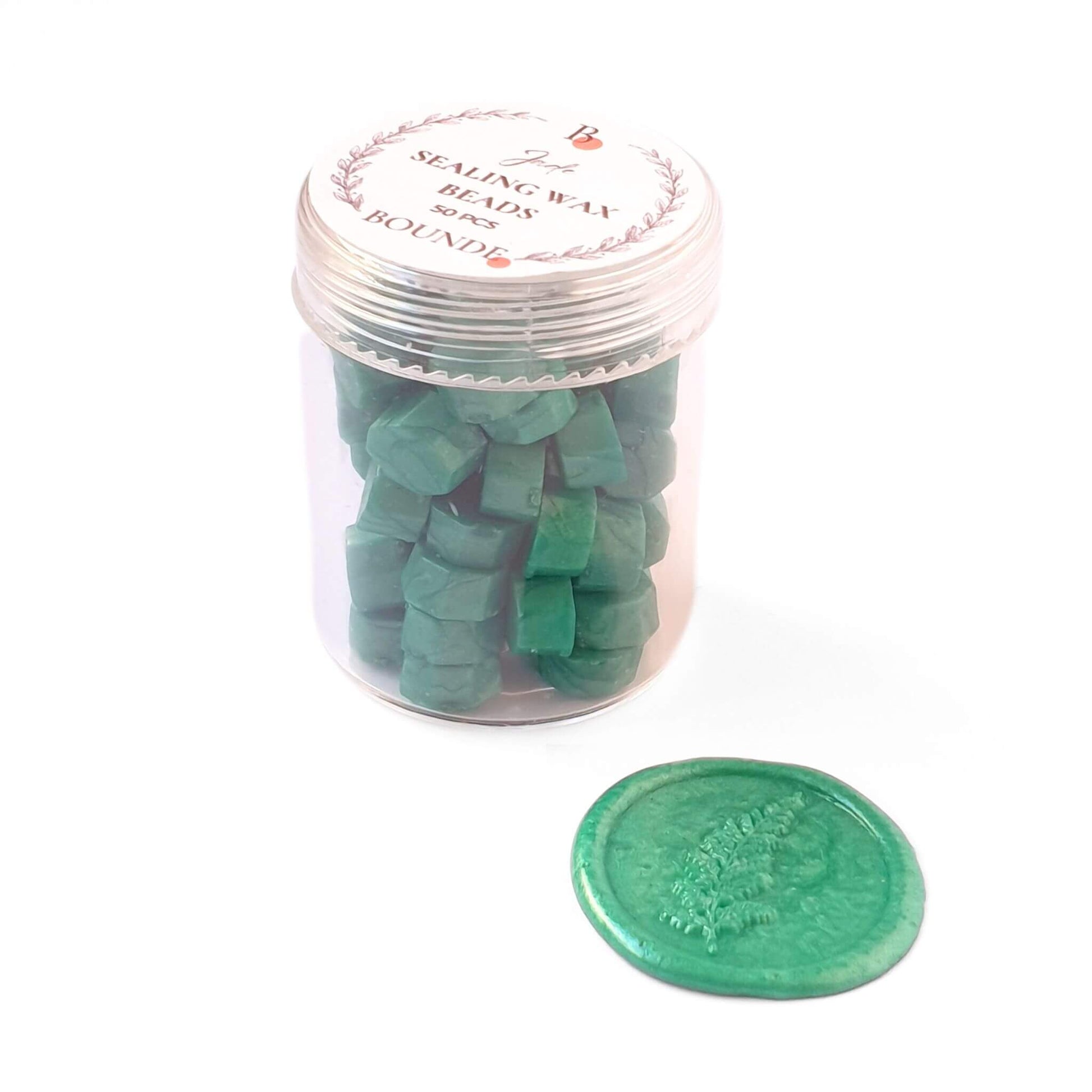 jade green wax sealing beads in jar with fern leaf wax seal in green