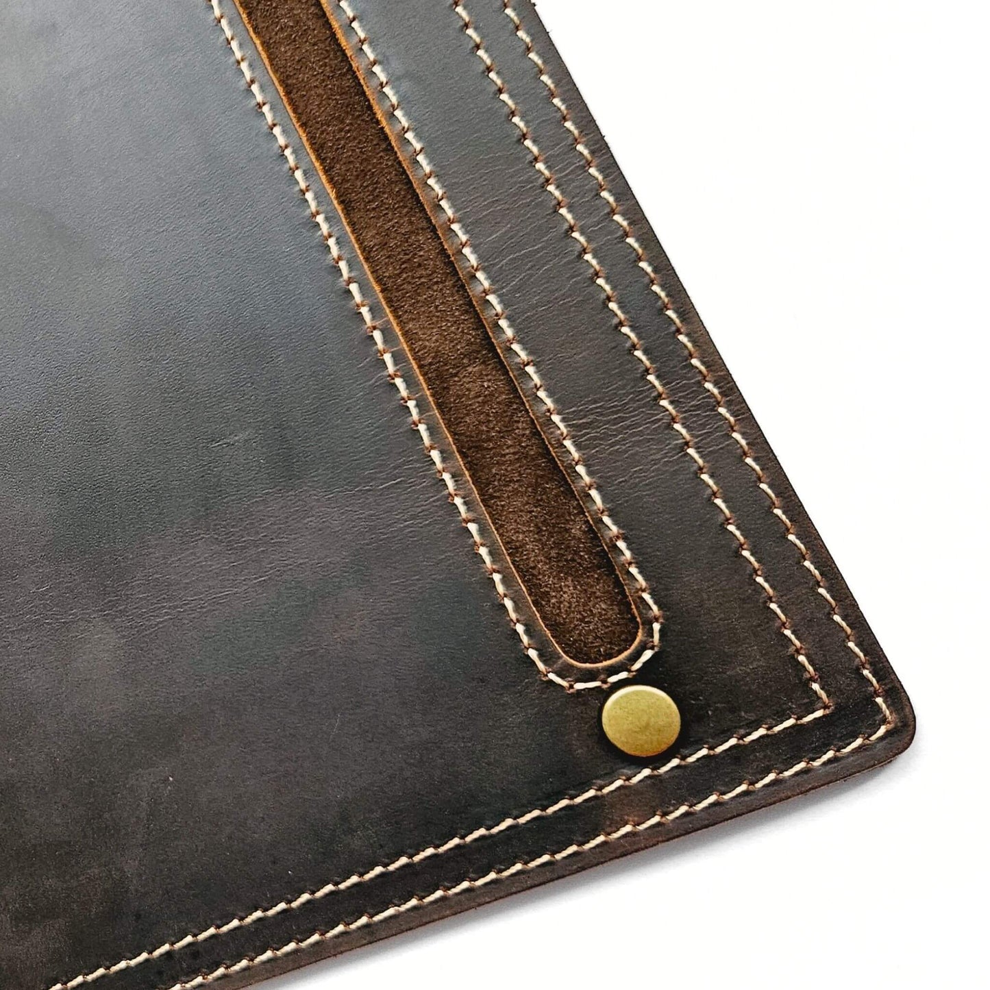 close up of stitching detail and brass studs on leather mouse pad