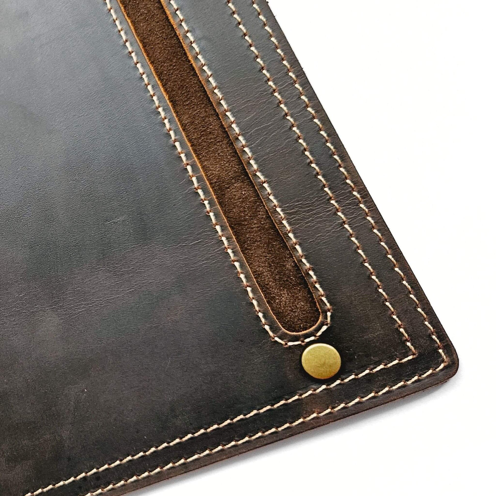 close up of stitching detail and brass studs on leather mouse pad