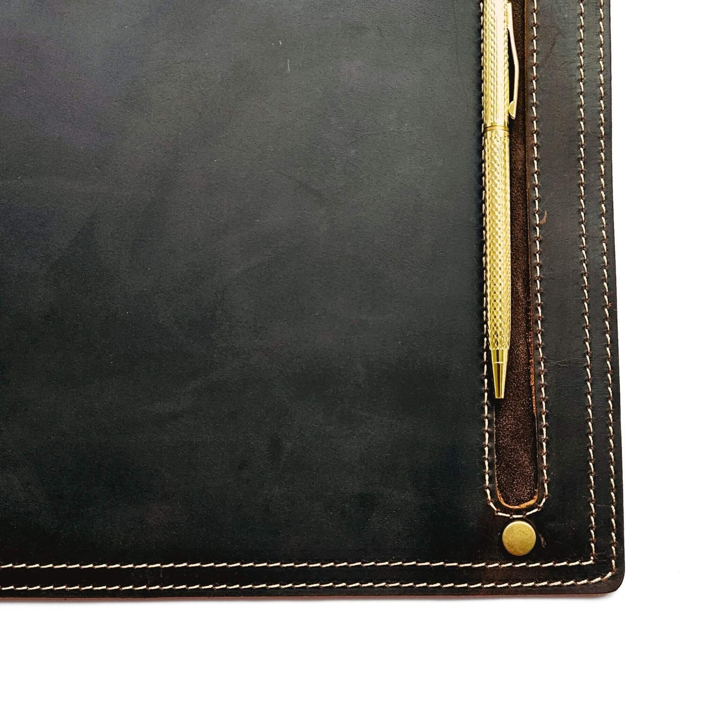 close up of pen or stylus holder on brown leather mouse pad