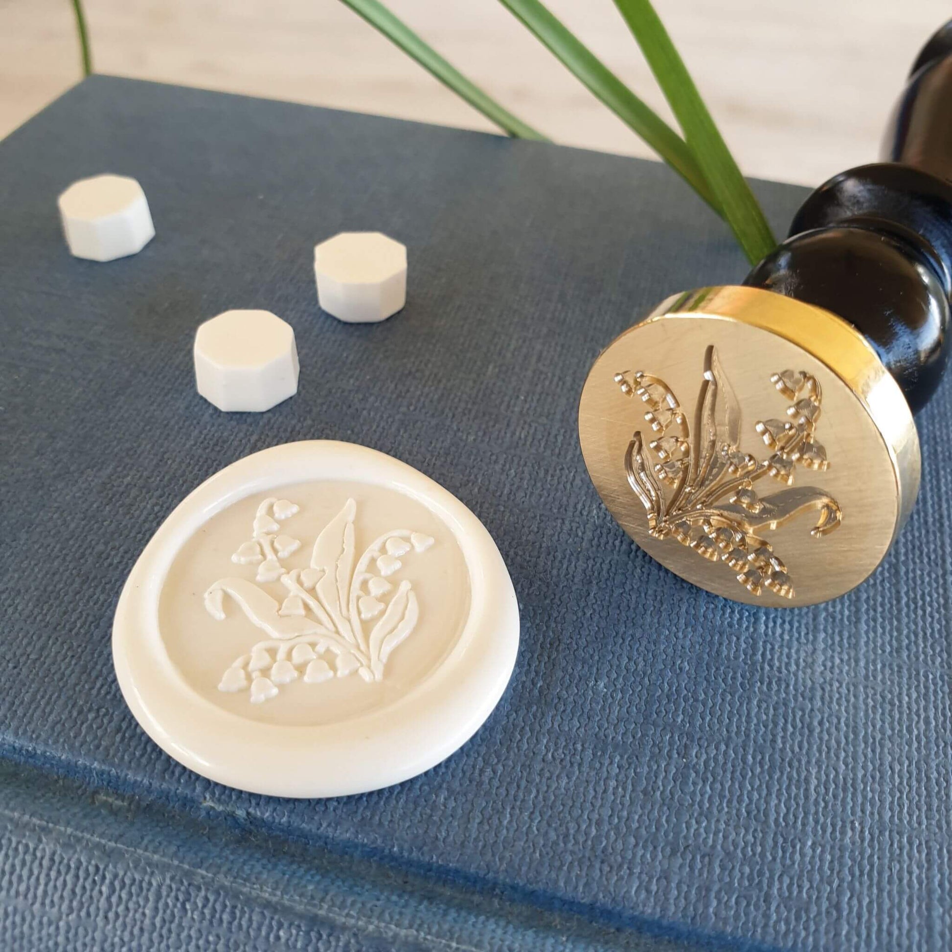 wax seal with lily of the valley design on vintage books