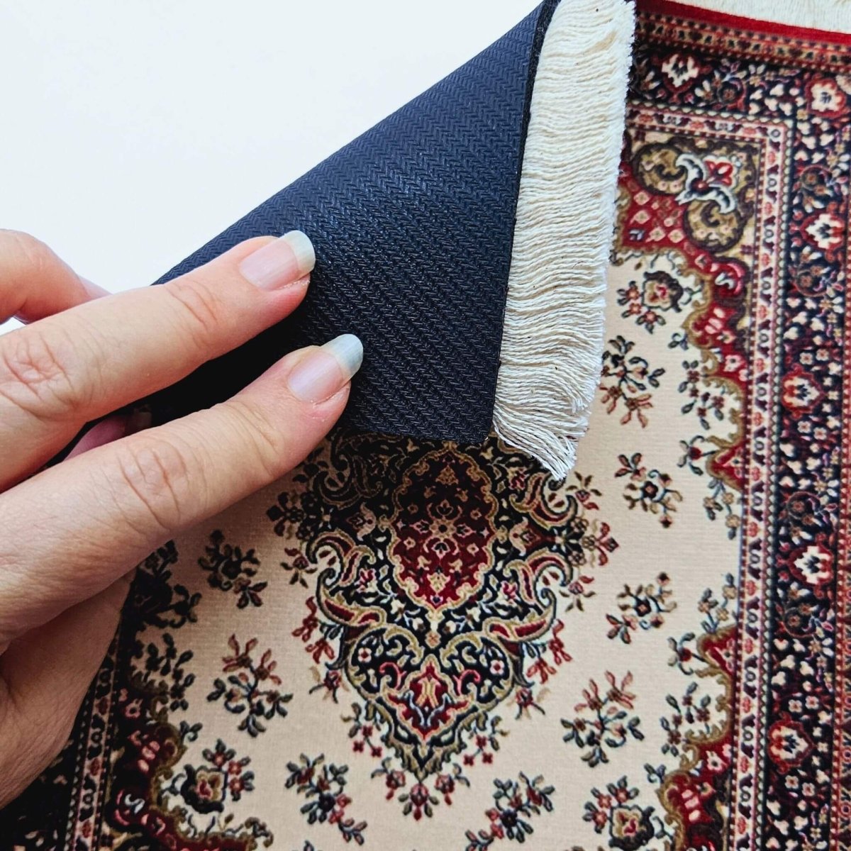 hand showing rubber underside of rug mouse pad