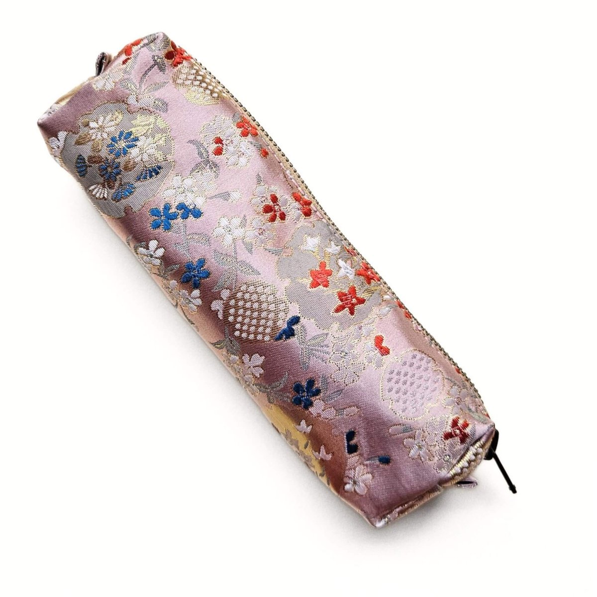 Pink floral patterned pen pouch on a white background
