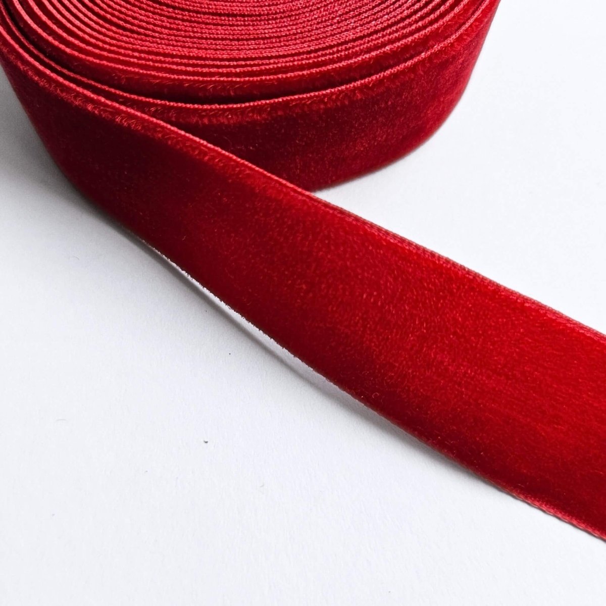 close up of roll of red velvet ribbon